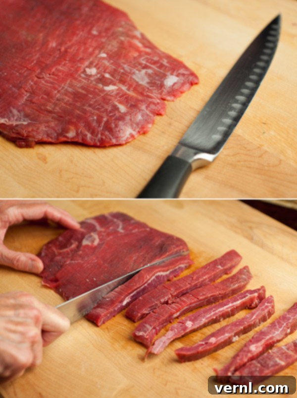Ginger Flank Steak-86 Ένα ολόκληρο κομμάτι flank steak σε ξύλο κοπής με ένα μαχαίρι έτοιμο για κοπή.