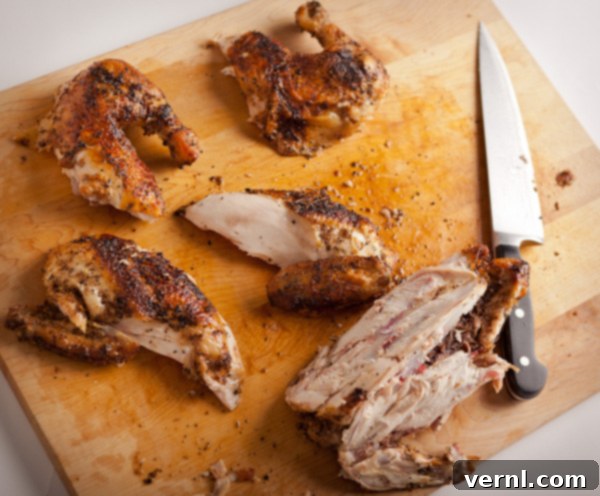 Whole Roast Chicken -0788 Carving a whole roast chicken on a cutting board.