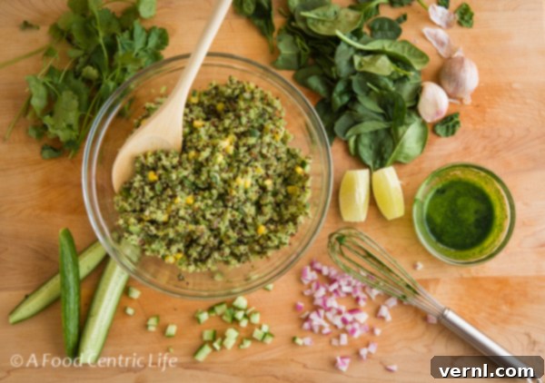 Σαλάτα Αβοκάντο Κινόα 3 Making the salad in a glass bowl on cutting board.