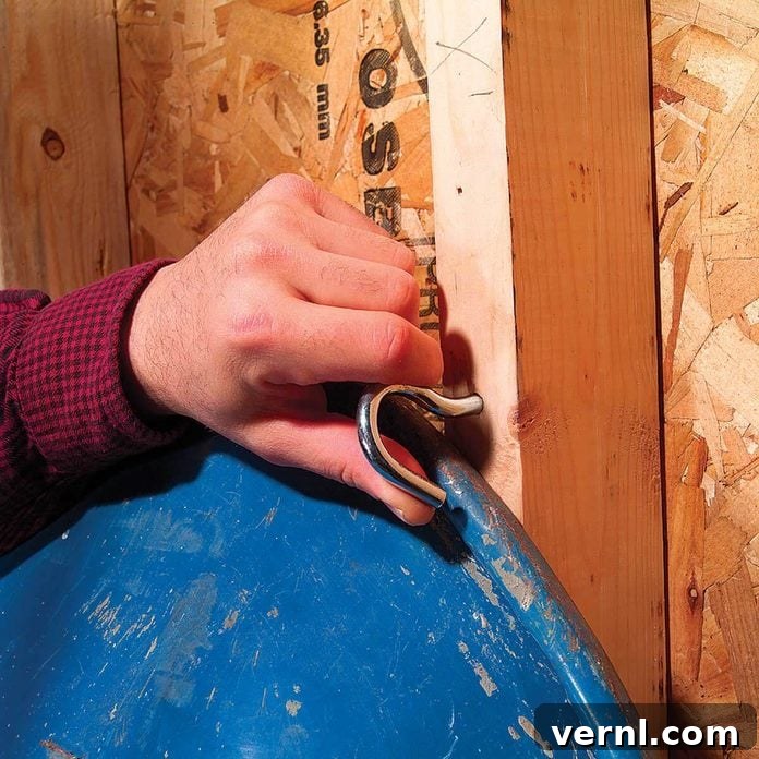 Master Your Wheelbarrow Storage with This DIY Rack 4 Ceiling hooks used as an upper catch for a wheelbarrow storage rack