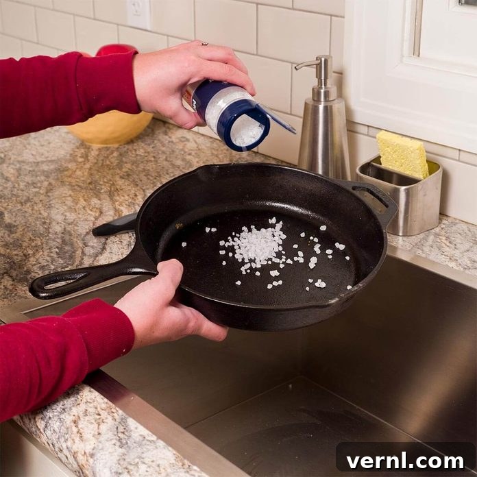 Mastering Cast Iron Skillet Care 2 clean cast iron skillet with coarse salt