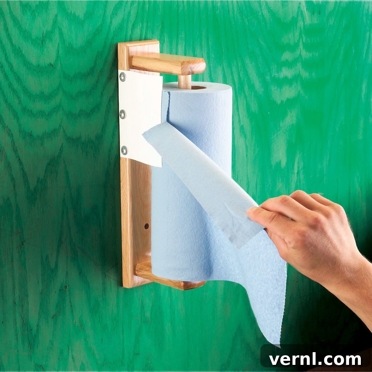 DIY paper towel dispenser with a plastic bottle brake, showing how to prevent unraveling and enable one-handed tearing.