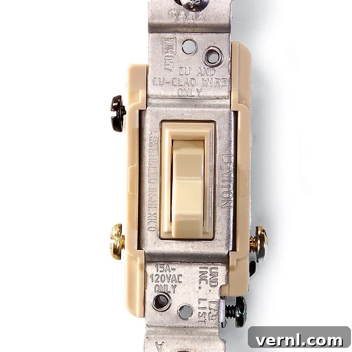Two Locations, One Light: The Magic of 3-Way Switches 2 Two identical light switches on a beige wall