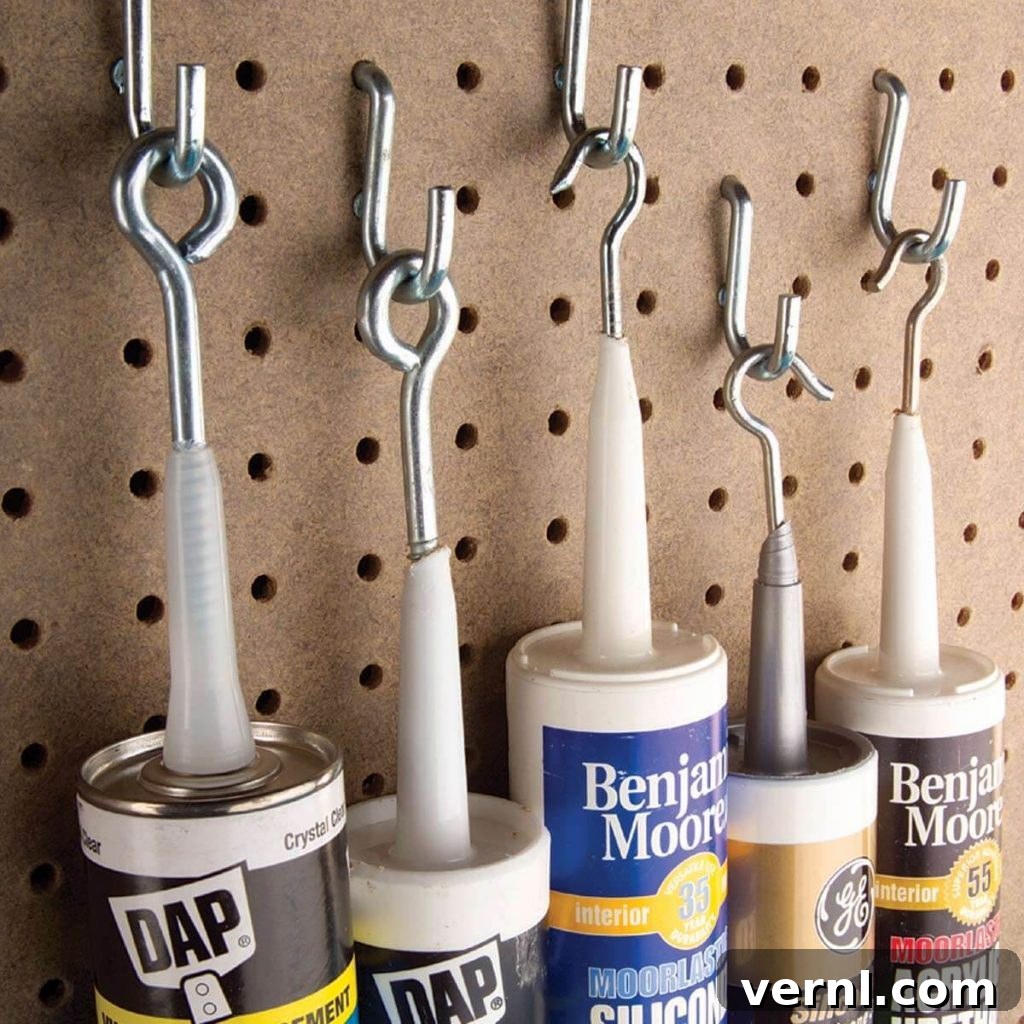 Preserving partially used caulk tubes with a screw eye or hook, showing a screw embedded in the nozzle and hanging on a Peg-Board