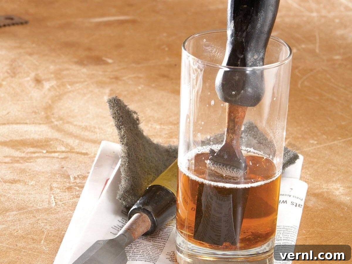 Revive Rusty Tools 2 Old rusty wood chisel being cleaned in a jar of white vinegar
