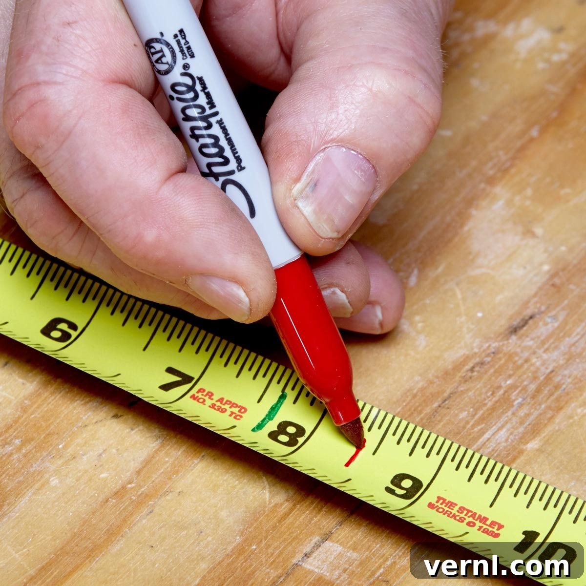 Person marking a tape measure for repetitive tasks