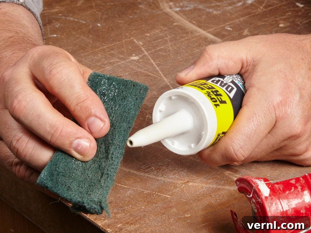 Achieving Flawless Caulk Finishes 2 Detail view of a caulk tube nozzle cut straight and rounded smooth for improved caulk bead application.
