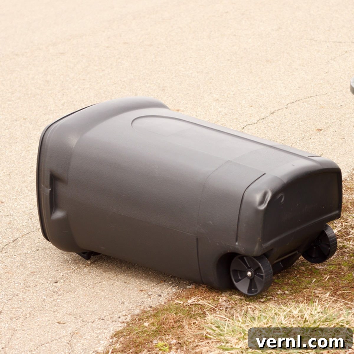 A securely anchored trash can standing firm against strong winds, illustrating effective wind-proofing.