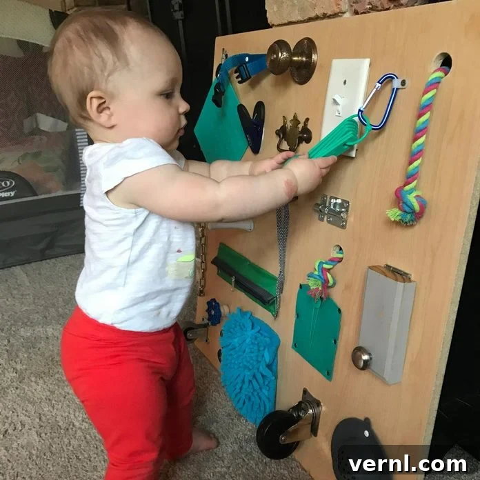 Craft a Toddler Busy Board from Everyday Essentials 6 A pair of adult hands meticulously checking the secure attachment and smooth edges of a newly crafted busy board, emphasizing the importance of safety inspections before use by a child.