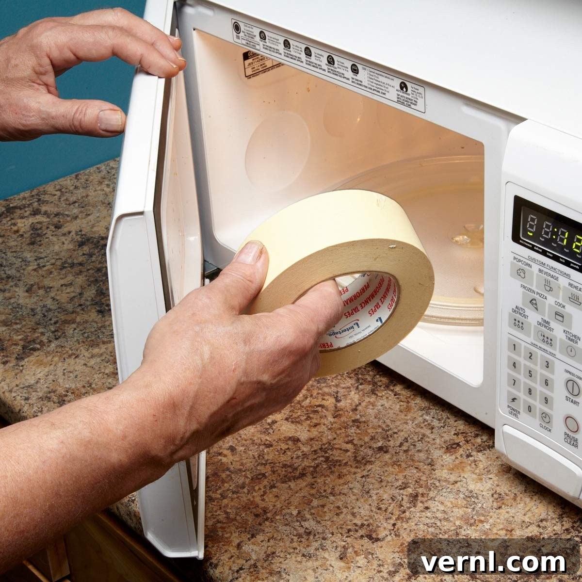 Reviving Stiff Masking Tape 2 Old masking tape roll next to a microwave, illustrating a solution for stiff tape