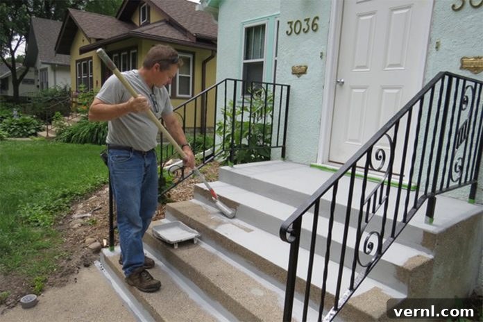 UGL NuDeck Concrete Solutions 11 Rolling NuDECK coating onto concrete stairs with a 1/2-inch nap roller and extension pole.