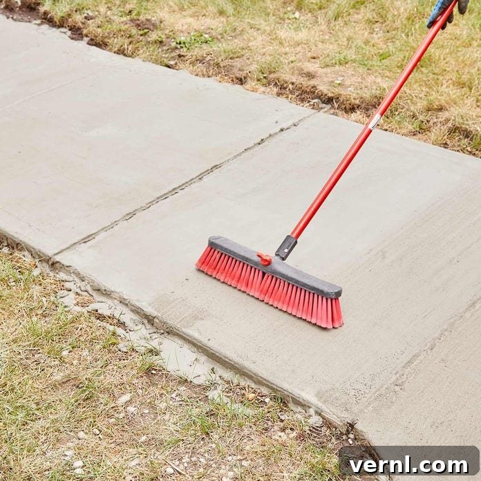 DIY Sidewalk Transformation: Easier Than You Imagine 13 Applying a broom finish to Sakrete Flo-Coat for improved traction and aesthetics