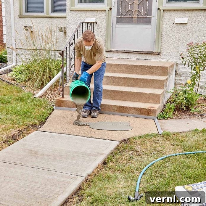 DIY Sidewalk Transformation: Easier Than You Imagine 9 Pouring Sakrete Flo-Coat Concrete Resurfacer onto the damp sidewalk surface