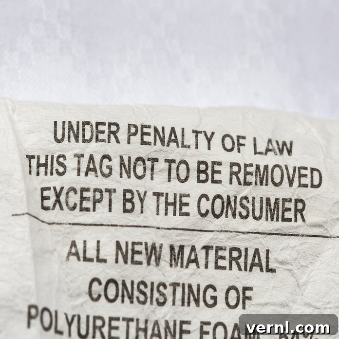 The Surprising Reason Your Mattress Tag Is Protected By Law 2 Mattress tag with 'Do not remove under penalty of law' warning, illustrating a common consumer myth about bedding regulations.
