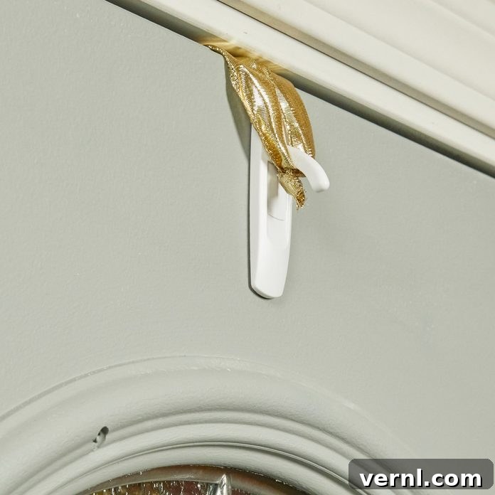Wreath hanging hack using a Command Hook and ribbon for damage-free door decoration
