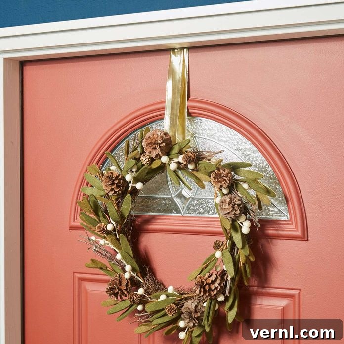 Interior view of a door showing an upside-down Command Hook holding a wreath ribbon for damage-free hanging