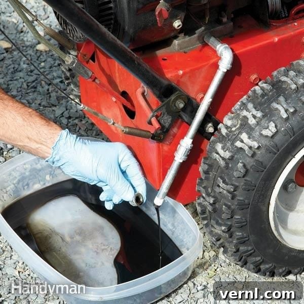 Weekend Project: Winterproof Your Home 4 A person checking the oil level of a snow blower, performing pre-winter maintenance