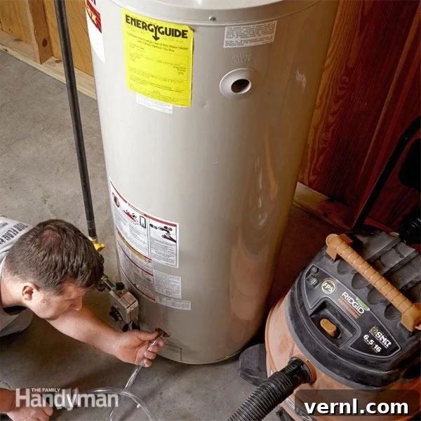 Weekend Project: Winterproof Your Home 6 A homeowner flushing a hot water heater, draining sediment to improve efficiency