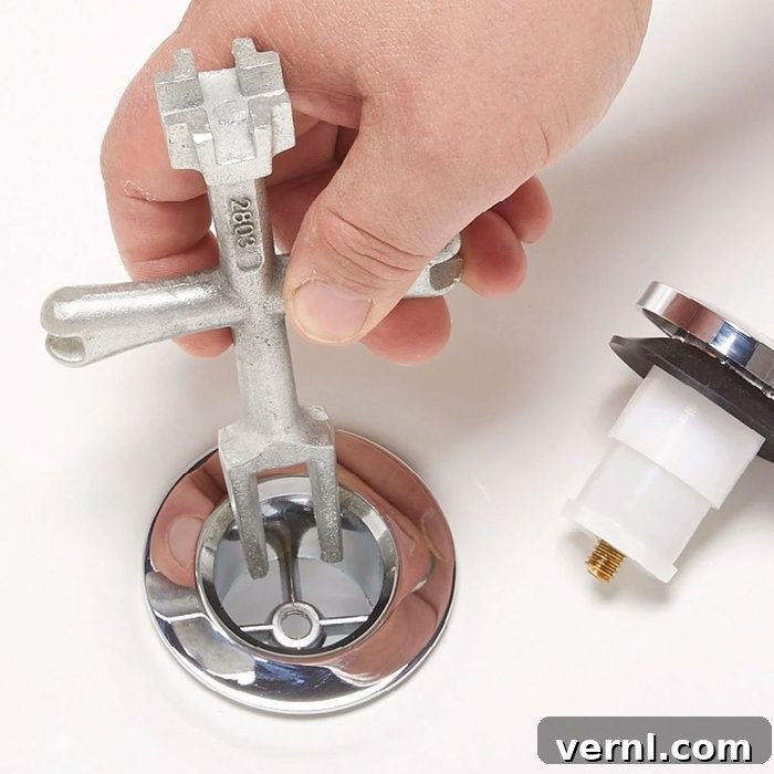 Unlock That Bathtub Drain 3 Loosening A Bathtub Drain Using A Drain Wrench With A Hand