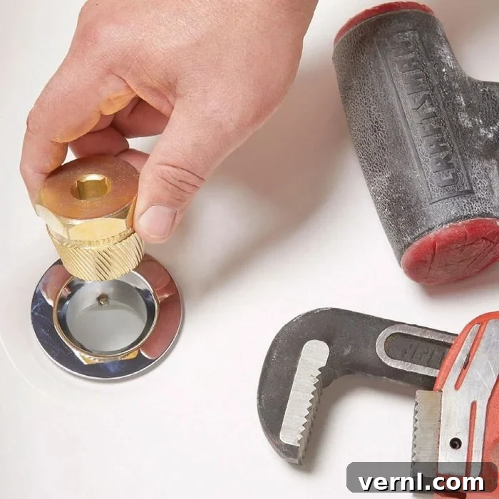 Unlock That Bathtub Drain 4 Loosening A Bathtub Drain Using A Drain Extractor With A Hand
