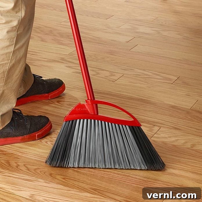 Close-up of a clean, natural-bristle broom standing upright, ready for effective sweeping