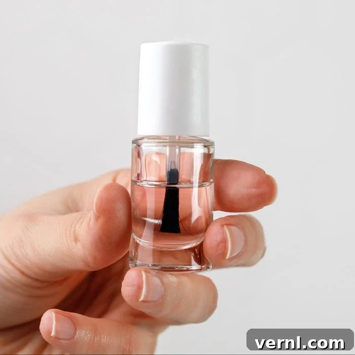 Erase Glass Scratches Effortlessly 3 Woman's hand holding bottle of nail polish. Firming transparent nail polish in female hand.