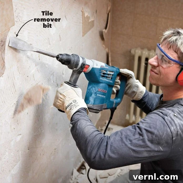 Rotary vs. Hammer Drills: Picking the Right Tool 6 Rotary hammer with a tile remover attachment effectively chipping away old floor tiles