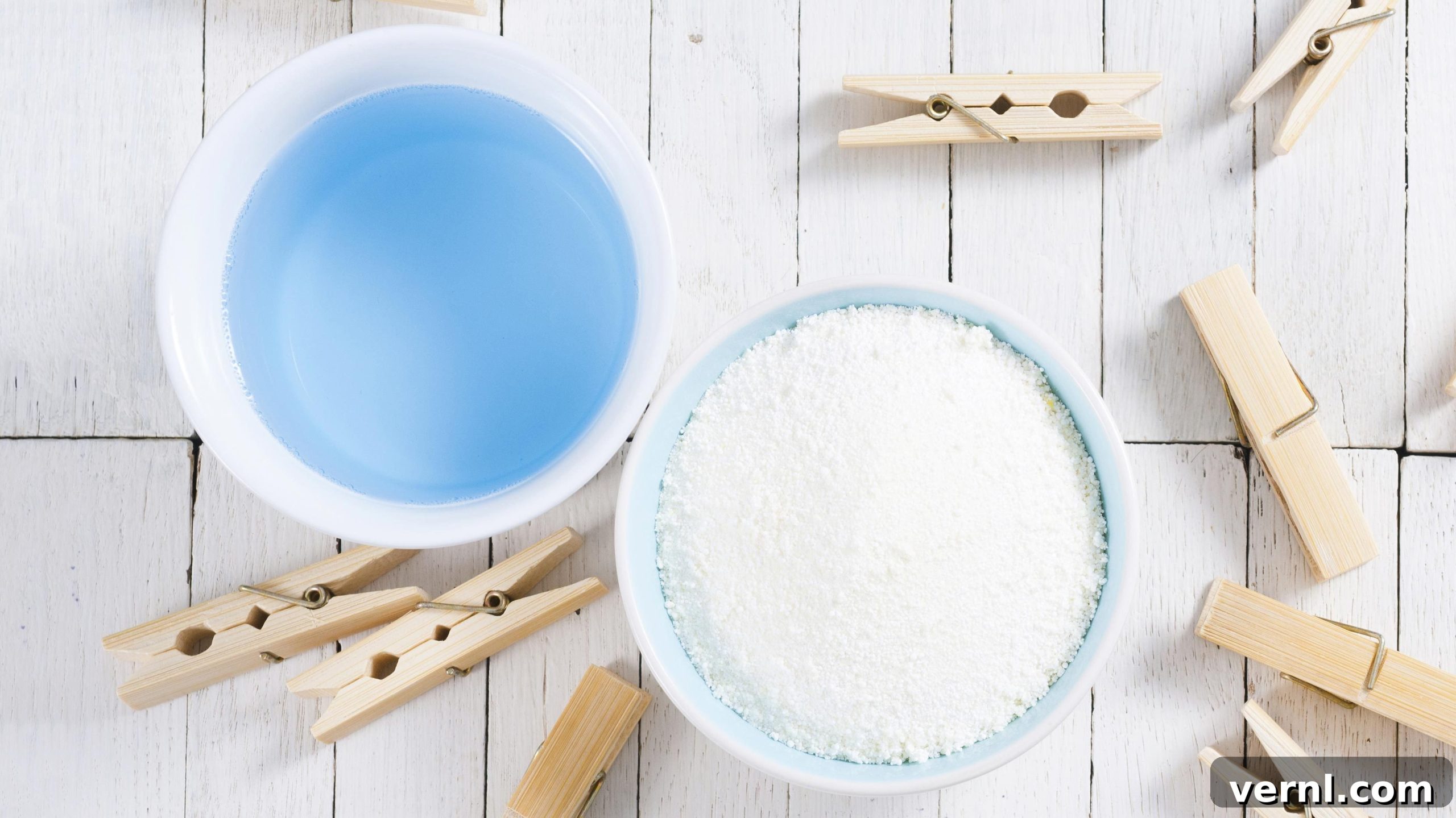 The Great Detergent Debate: Liquid Versus Powder 2 washing liquid and detergent powder with bamboo clothes pins on white wooden