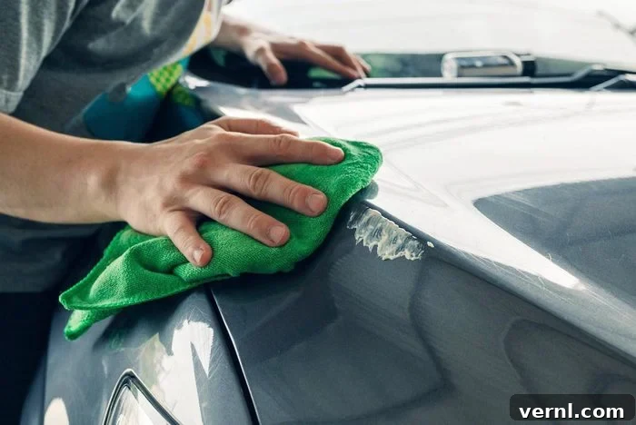 Scratch Free Shine Your Ultimate Guide to Car Paint Correction 4 Man cleaning scratch on car with microfiber cloth and cleaner remover