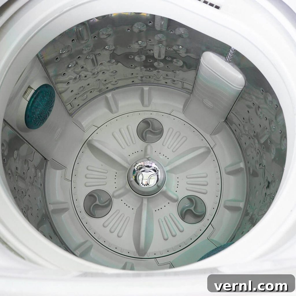 Your Washer's Hidden Filter: How to Find It and Why Cleaning It Matters 2 Washing machine drum interior with clothes, highlighting a clean and functional appliance. Essential for optimal laundry care.