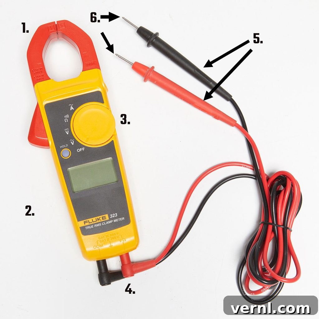 Essential Digital Clamp Multimeter for Electrical Measurements A high-quality digital clamp multimeter displays various readings, with its red and black test leads neatly attached, resting on a clean surface while precisely measuring electrical current from a circuit. This essential tool is vital for accurate diagnostics and safety in electrical work.