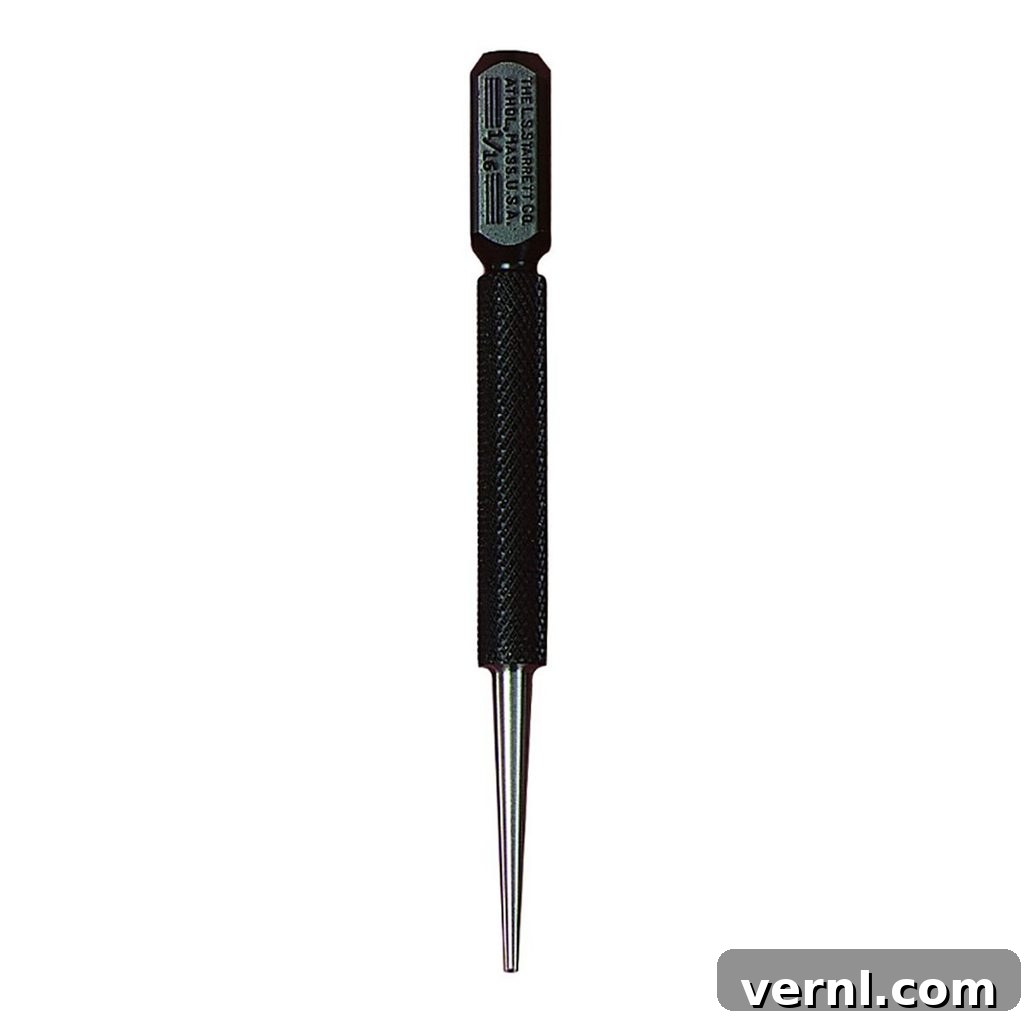 A close-up view of a standard nail set with a metal grip and a precision tip, highlighted against a neutral background.