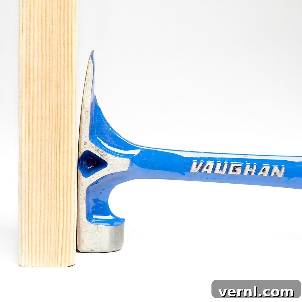 A flat hammer head top A flat hammer head top pushed against wood| Construction Pro Tips