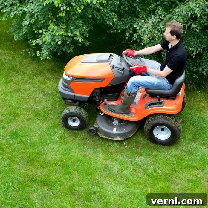 Man mowing a large lawn with a riding lawn mower