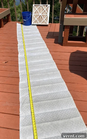 The filter media of a 21 x 23.5 x 5-inch pleated filter stretched out to its full length.