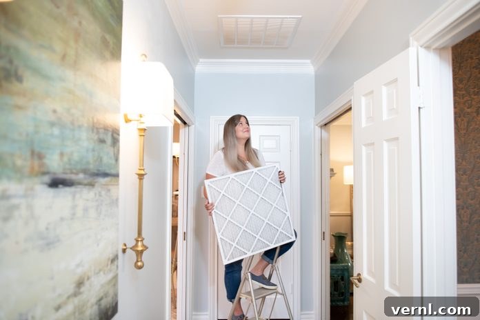 Mastering HVAC Ownership 3 Woman climbing up a small ladder in the corridor holding a duct cover for her home's ventilation system