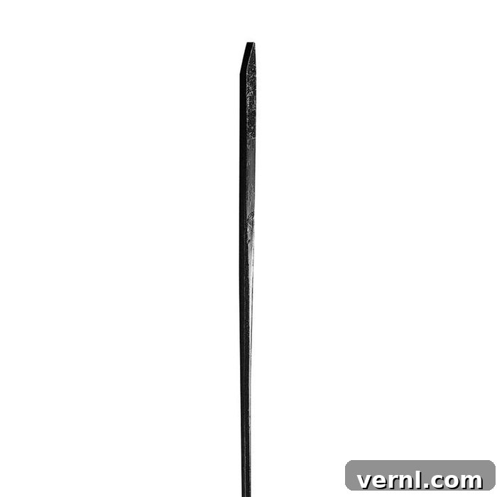 Close-up of a pinch point pry bar head, showing its tapered wedge shape.