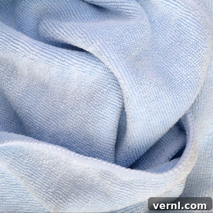 A vibrant blue microfiber cleaning cloth, essential for various household tasks. Blue microfiber cleaning cloth