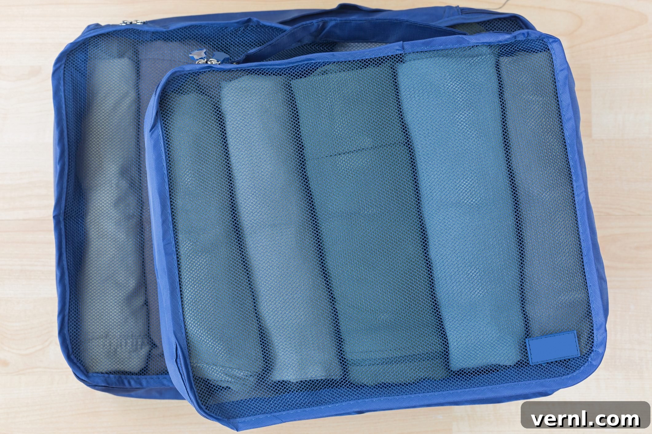 Cube Meshed Bags With Rolled Clothes. Set Of Travel Organizer To Help Packing Well Organized