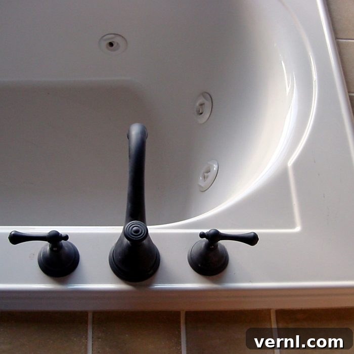 Your Essential Guide to Bathtubs 4 top view of white jacuzzi bathtub with black faucet