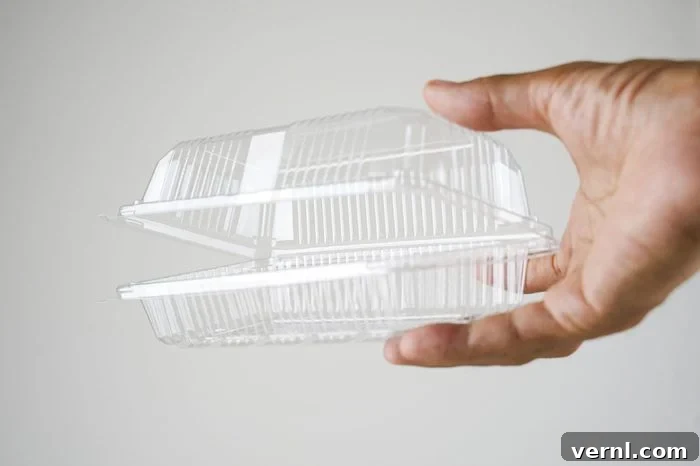 Beyond the Bin: 11 Clever Takeout Container Transformations 3 hand holding plastic take out container