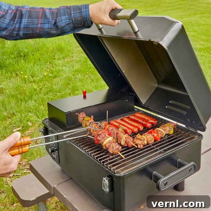 Z-Grills Cruiser 200A Portable Pellet Grill smoking a pork loin, highlighting its compact form and wood pellet hopper.