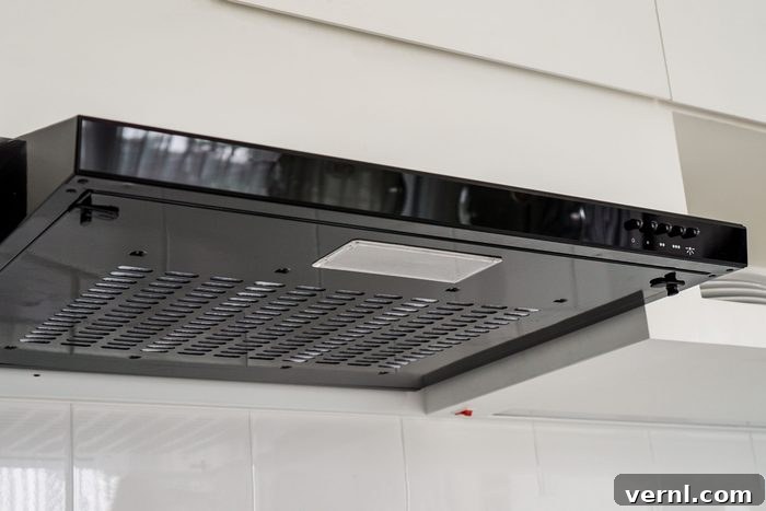 Ventless Ventilation: Your Guide to Ductless Range Hoods 2 Sleek black ductless range hood in a modern kitchen, highlighting integrated lighting and efficient design