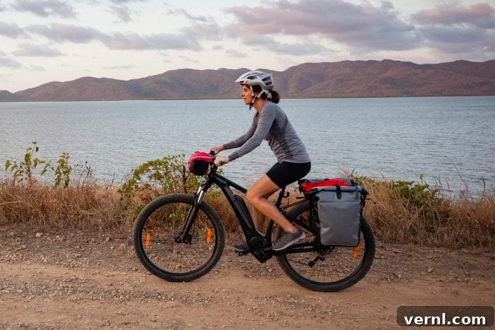 woman riding an e bike next to a lake and mountains
