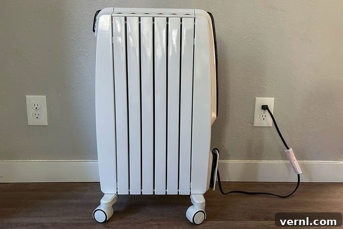 Electrician-Approved: The 3 Safest Space Heaters for Your Home 3 Side view of space heater on wooden floor in a bedroom setting