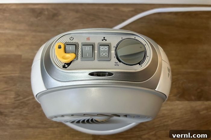 Electrician-Approved: The 3 Safest Space Heaters for Your Home 7 Top view of a Vornadobaby Tempa nursery heater with a yellow button, indicating controls