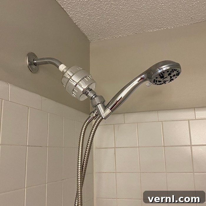 Person showering with the AquaHome filter