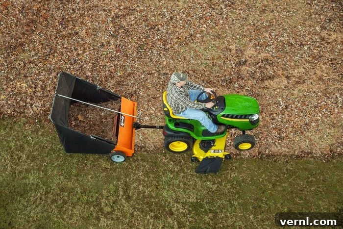 top view of a man on a tractor using a Agri Fab Lawn Sweeper