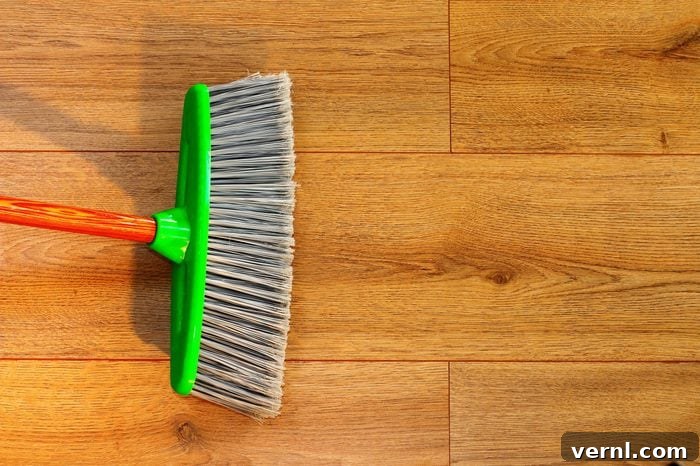 Mastering Hardwood Floor Disinfection 2 cleaning wooden floor with broom