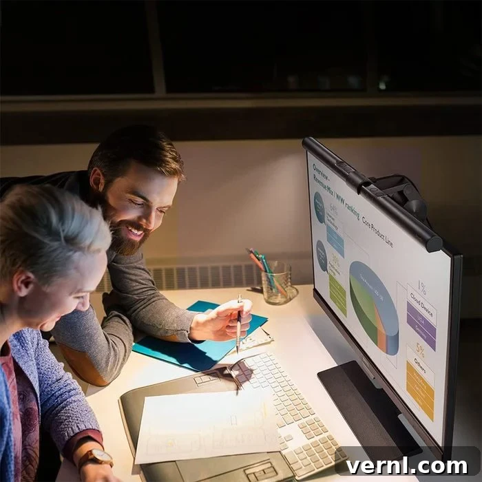 Benq Screenbar Monitor Light on a computer with two people working at a desk together